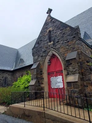 A sign is posted on the door of the former St. Mary’s Protestant Episcopal Church at 3900 Roland Ave. Photo by Ed Gunts.