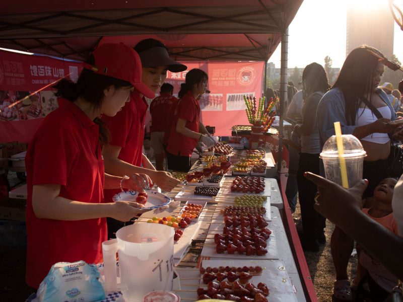 Employees at Chan Nei Mei sell tanghulu, a popular Chinese candied fruit treat, at Baltimore's Asia in a Bite Festival on July 27, 2024. Photo by Maggie Jones.