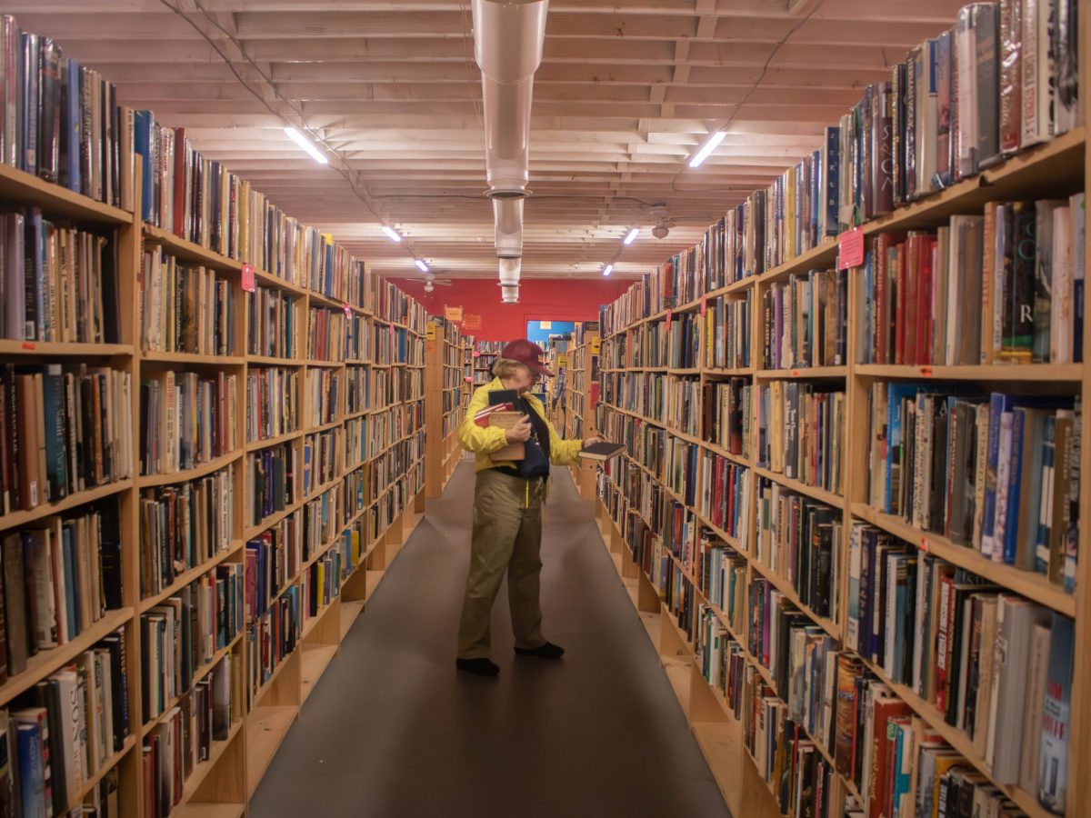 Laura Day browses The Book Thing in Baltimore, Maryland on Sept. 29, 2024. Photo by Maggie Jones.