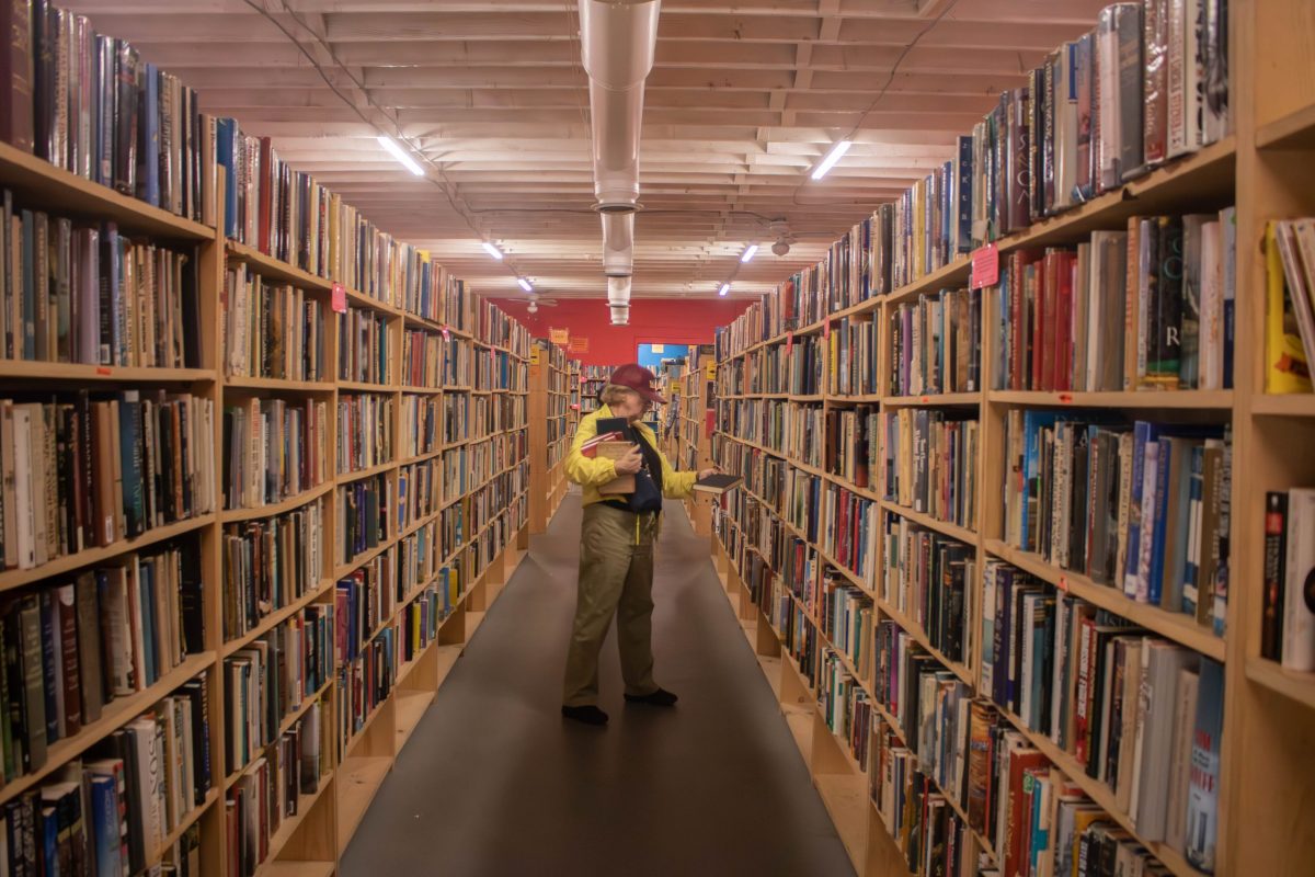 Laura Day browses The Book Thing in Baltimore, Maryland on Sept. 29, 2024. Photo by Maggie Jones.