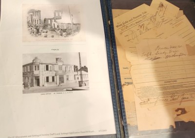 photos in book of cable office in St. Thomas with yellowed papers next to it