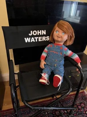 A Chucky doll sits on a chair labeled with the name of Baltimore writer, filmmaker and actor John Waters. Photo courtesy of SYFY.