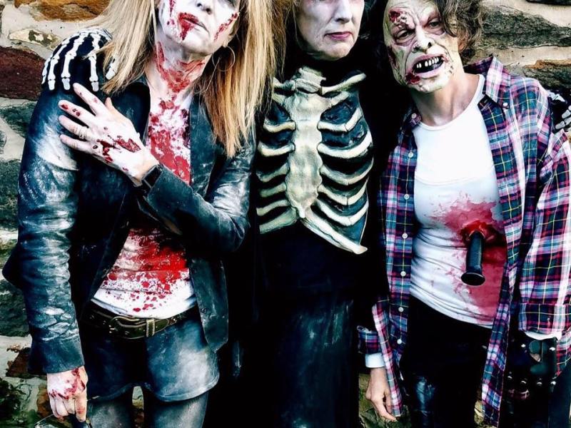 three women in zombie costumes and makeup