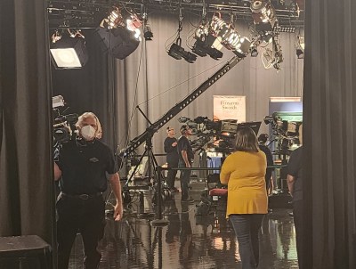 black open curtains lead to filming area in tv studio