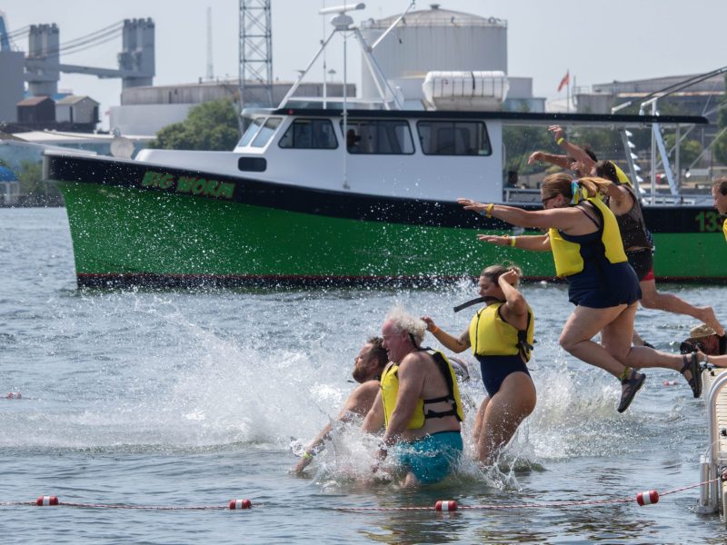 Baltimore residents jump into Baltimore's Inner Harbor at the 2024 Harbor Splash on June 23, 2024. Photo by Maggie Jones.