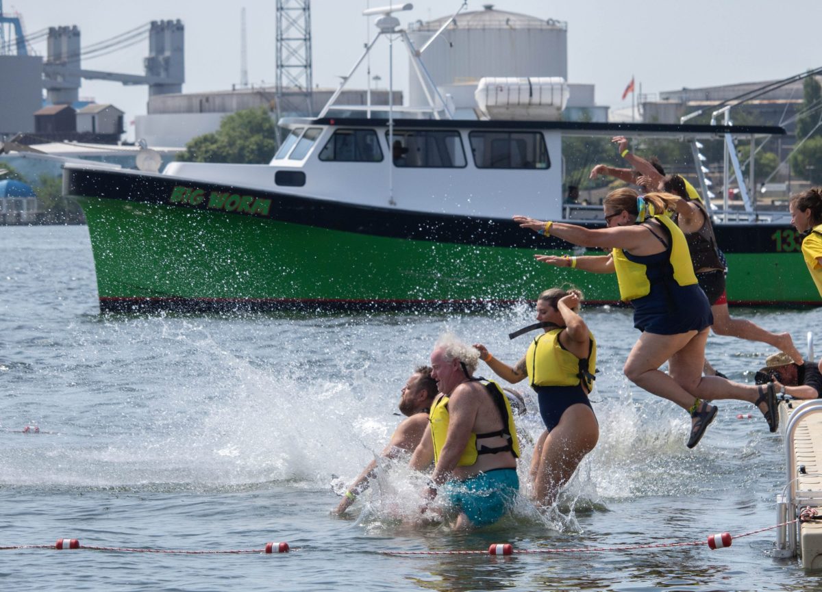 Baltimore residents jump into Baltimore's Inner Harbor at the 2024 Harbor Splash on June 23, 2024. Photo by Maggie Jones.