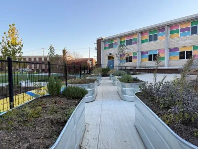 Plants grow in metal raised garden beds at Cecil Community Park.