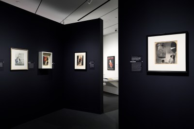 Artworks are displayed in the newly unveiled Irene and Richard Frary Gallery at Johns Hopkins University's Hopkins Bloomberg Center in Washington, D.C. Art hangs on black walls.