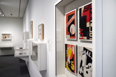 Artworks are displayed in the newly unveiled Irene and Richard Frary Gallery at Johns Hopkins University's Hopkins Bloomberg Center in Washington, D.C. Art with the word "Signals" hangs in a glass box against a white wall.