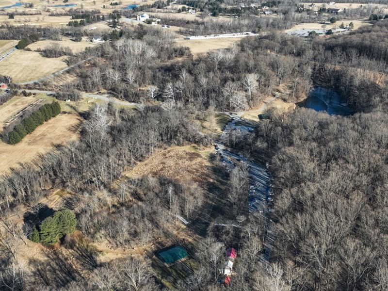 A drone image shows a birds-eye view looking northeast across Oregon Ridge Park, with Shawan Road on the left, Nature Center in the middle, and the Lodge at the top right. Photo courtesy of Baltimore County Recreation & Parks.