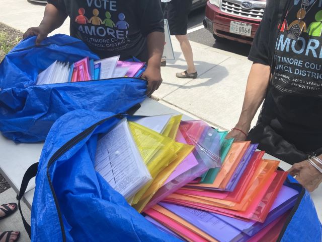 Petitions with more than 10,000 signatures are delivered to the Baltimore County Board of Elections Monday to try to put a question on the ballot calling for a four seat expansion of the County Council. Photo by John Lee/WYPR.