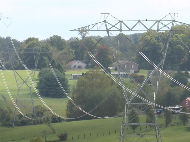 Power lines stretch over fields. Screenshot via video by Nathan Schwartz/Capital News Service.