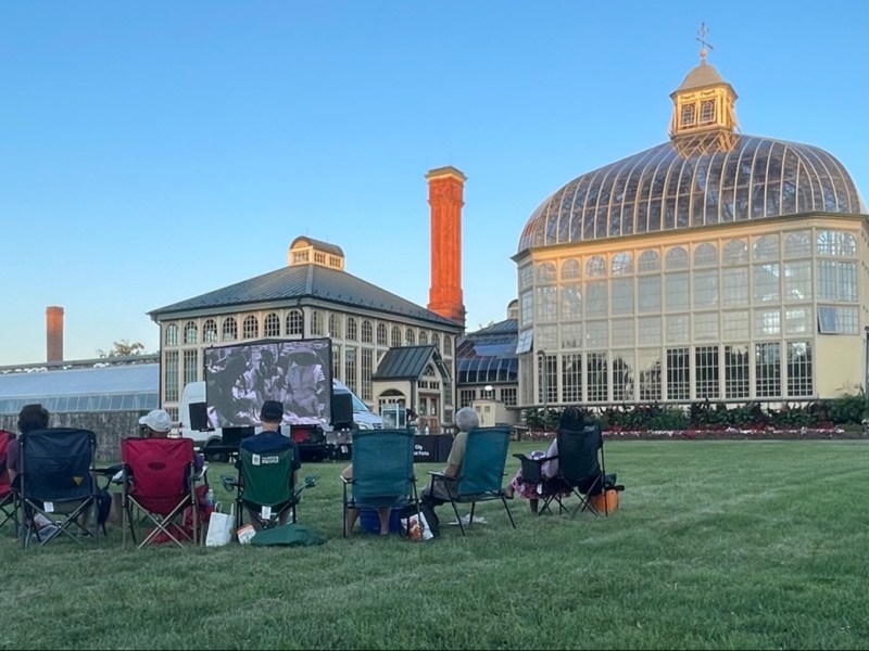 Visitors watch an outdoor movie at the H.P. Rawlings Conservatory & Botanic Gardens. Photo by Maggie Jones.