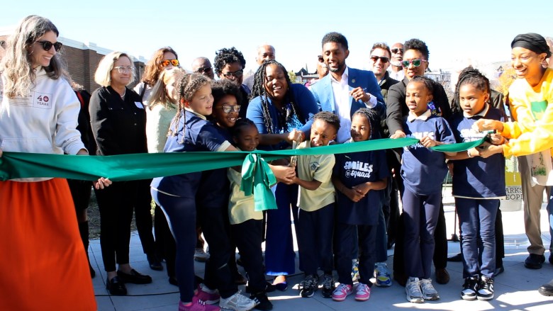 Cecil Elementary School students help Baltimore City officials and community members cut a ceremonial ribbon at the grand opening of the newly renovated Cecil Community Park. Photo courtesy Parks & People.