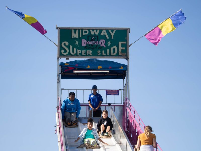 Fairgoer Chloe glides down the Midway Super Slide at the Maryland State Fair on September 8, 2024. Photo by Maggie Jones.