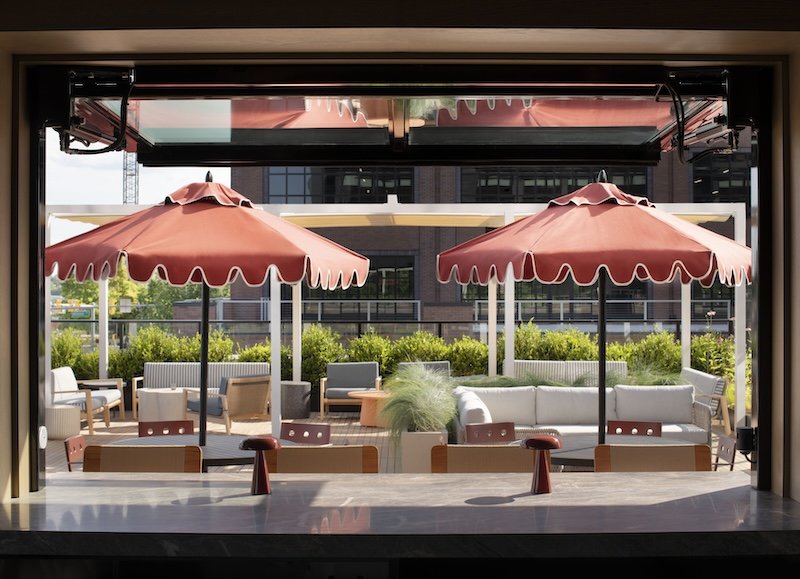 Umbrella-shaded tables at the Vessel bar and lounge.