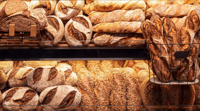 baker's case filled with different kinds of breads