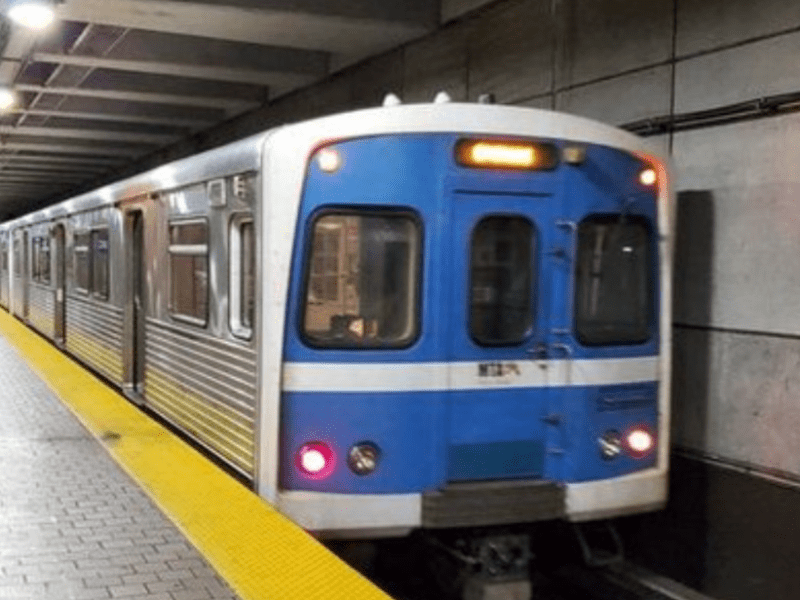 subway train with blue front at platform underground